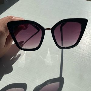 Large Aldo black sunglasses with gold accents.